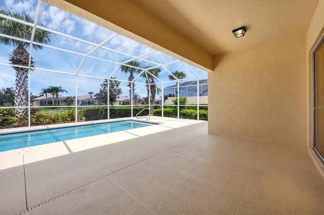 view of pool with a patio area and a lanai