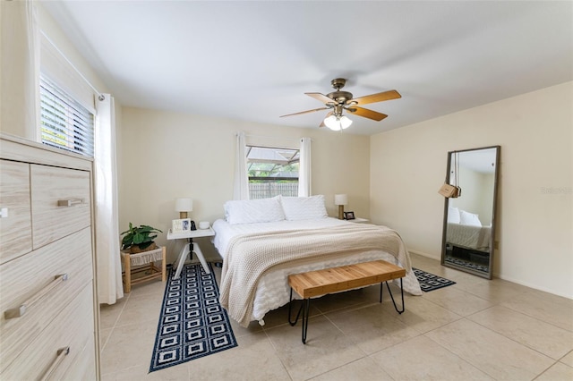 tiled bedroom featuring multiple windows and ceiling fan