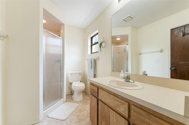 bathroom with tile patterned flooring, vanity, toilet, and a shower with shower door