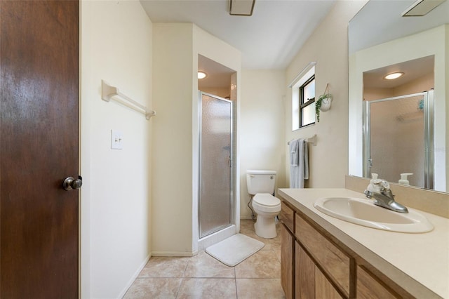 bathroom featuring toilet, vanity, tile patterned floors, and a shower with shower door