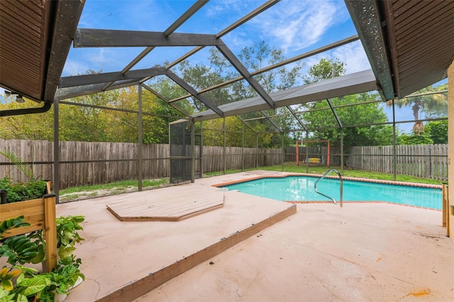 view of pool featuring glass enclosure and a patio area