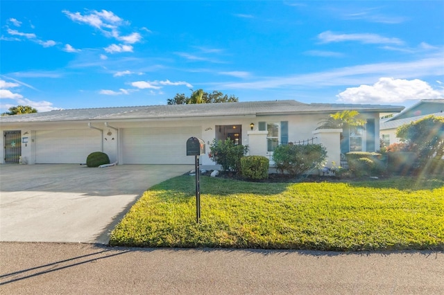 single story home with a garage and a front lawn