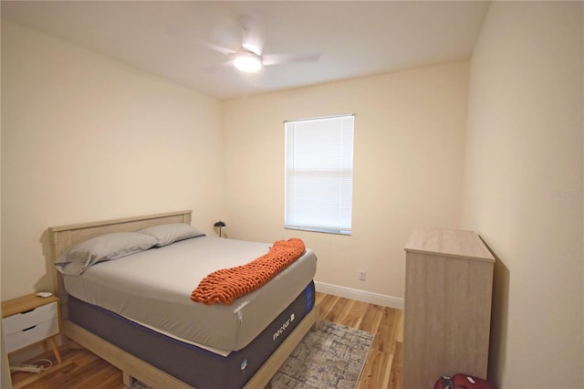 bedroom with light hardwood / wood-style flooring and ceiling fan