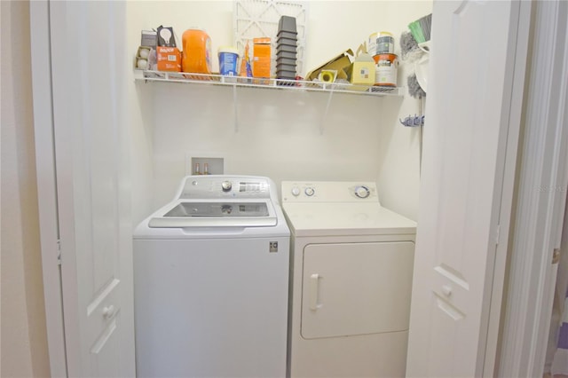 clothes washing area featuring washer and clothes dryer