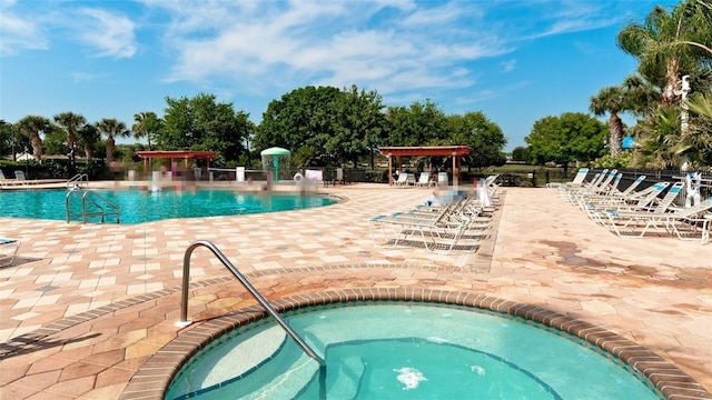 view of pool featuring a community hot tub and a patio