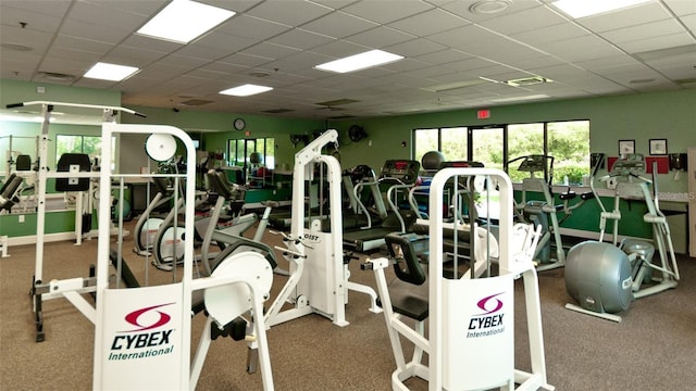 gym with a paneled ceiling