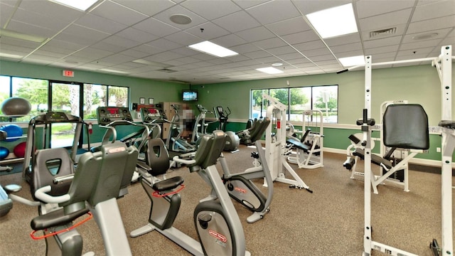 exercise room featuring a drop ceiling and plenty of natural light