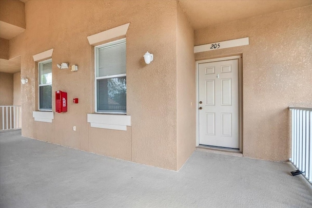 property entrance featuring stucco siding