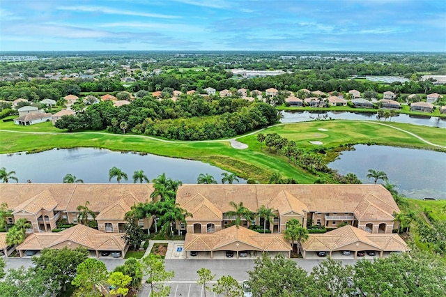 aerial view featuring a residential view, golf course view, and a water view