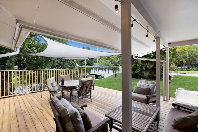 deck with a lawn, an outdoor living space, and a water view