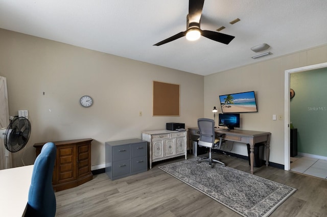 office with ceiling fan and light hardwood / wood-style flooring