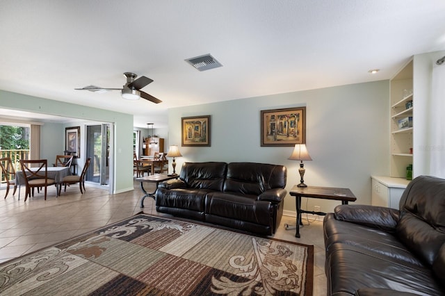 living room featuring light tile patterned floors and ceiling fan