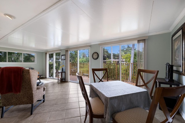 tiled dining area featuring ornamental molding