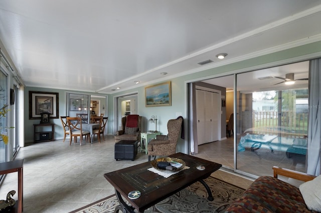 living room with ceiling fan, crown molding, and light tile patterned floors