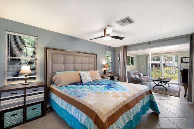 tiled bedroom featuring ceiling fan