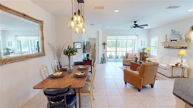 dining area featuring ceiling fan and light tile floors