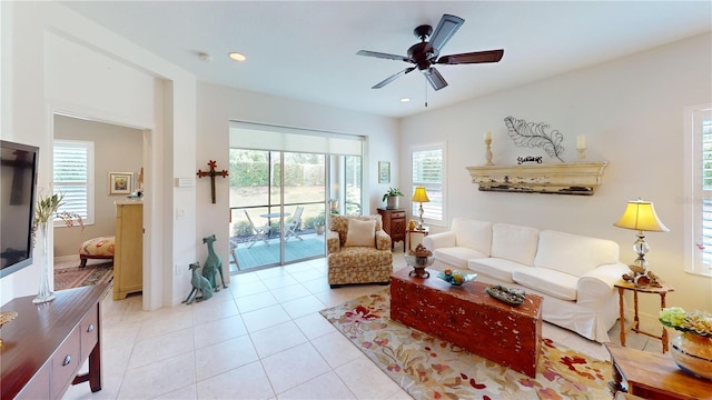 tiled living room featuring ceiling fan and a healthy amount of sunlight