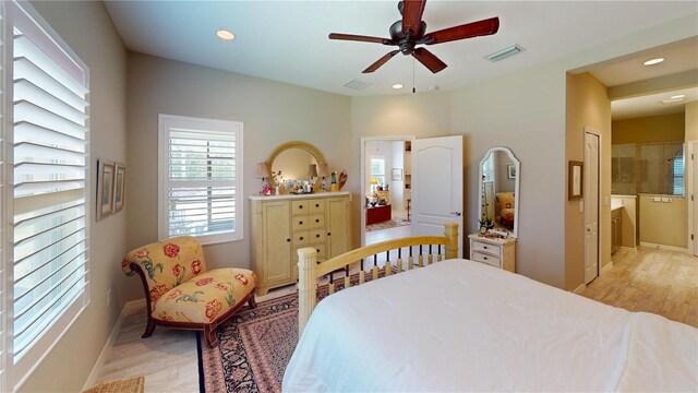 bedroom featuring light wood-type flooring, connected bathroom, and ceiling fan