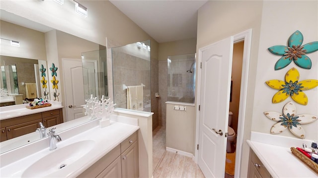 bathroom featuring walk in shower, vanity, and tile floors