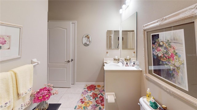 bathroom with tile floors, vanity, and toilet