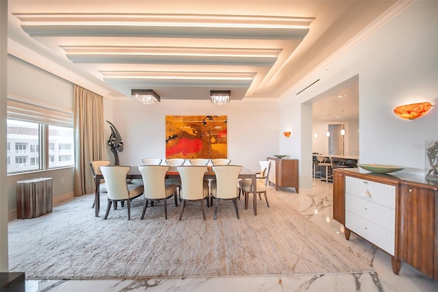 dining area featuring crown molding and a chandelier