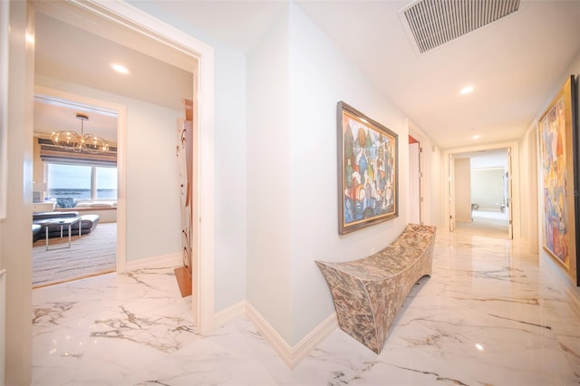 hallway featuring a chandelier