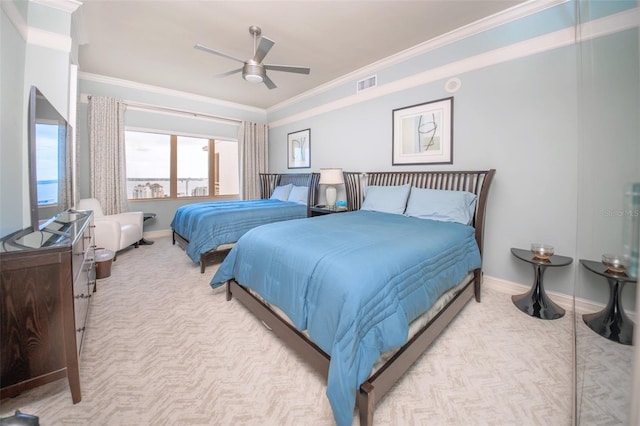 carpeted bedroom with ceiling fan and ornamental molding