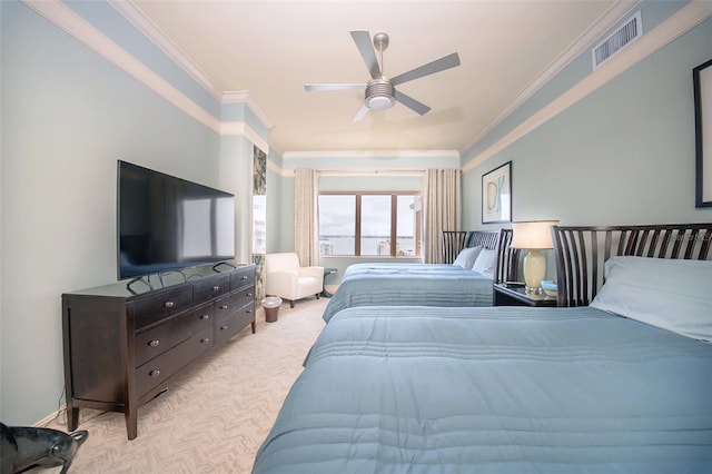 carpeted bedroom with ceiling fan and ornamental molding