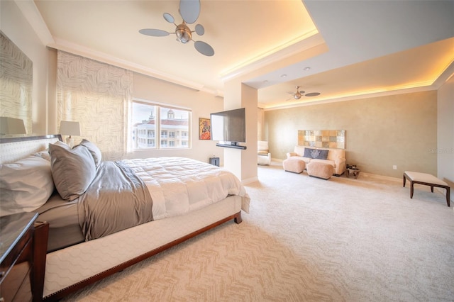 bedroom featuring a raised ceiling, ceiling fan, crown molding, and carpet floors