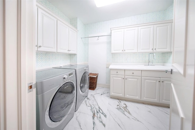 laundry room featuring sink, cabinets, and independent washer and dryer