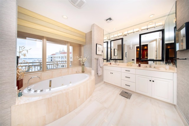 bathroom featuring vanity and tiled bath