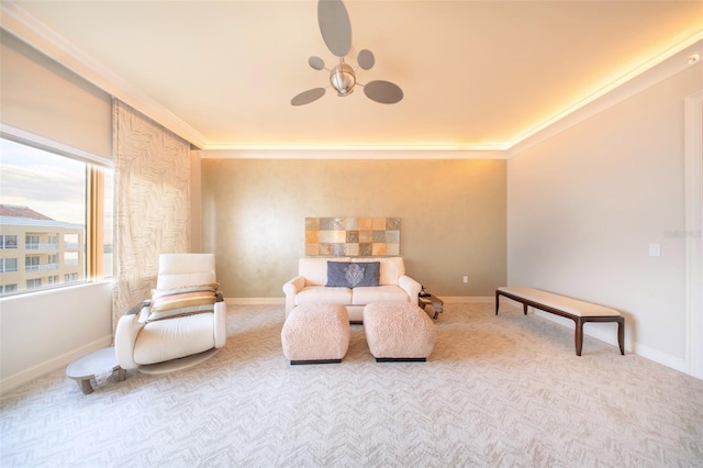 sitting room with light colored carpet and ornamental molding