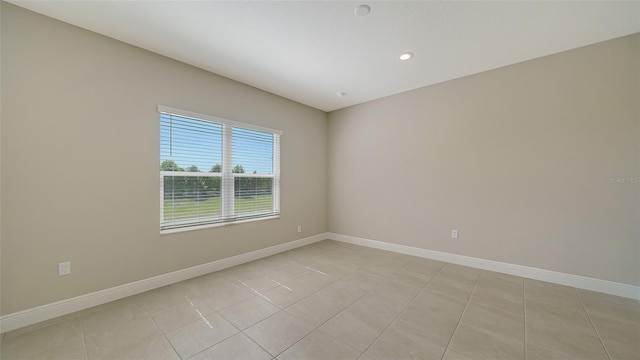 unfurnished room featuring light tile patterned floors