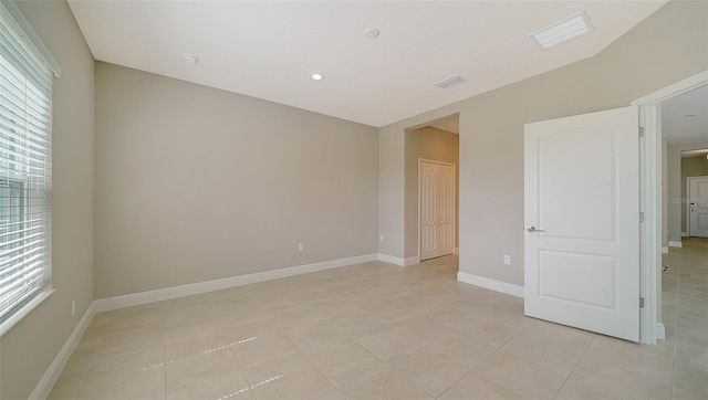 unfurnished bedroom featuring multiple windows, a closet, and light tile patterned floors