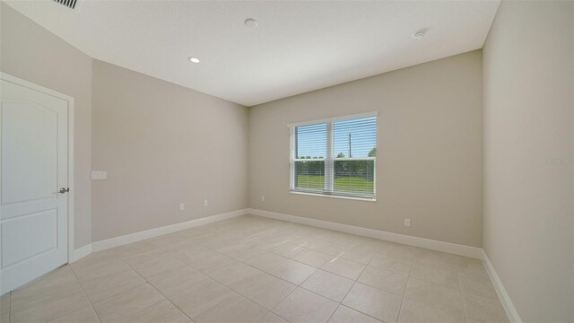 unfurnished room featuring light tile patterned floors