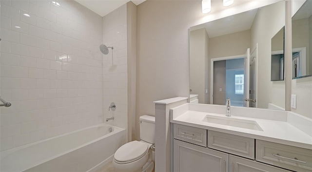 full bathroom with vanity, tiled shower / bath, and toilet