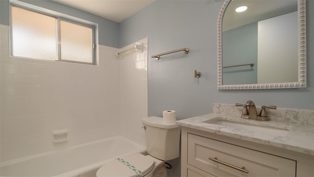 full bathroom featuring toilet, vanity, and tiled shower / bath