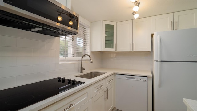 kitchen featuring white appliances, white cabinets, decorative backsplash, and sink