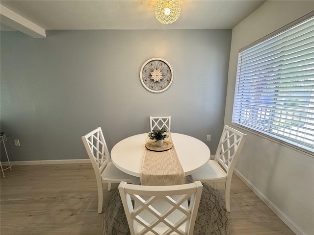 dining area featuring baseboards and wood finished floors