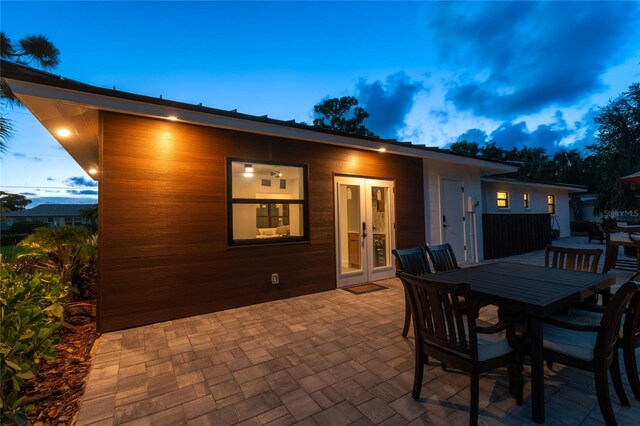 patio terrace at dusk featuring french doors