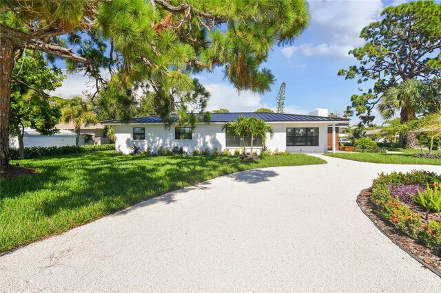 ranch-style home with a front yard