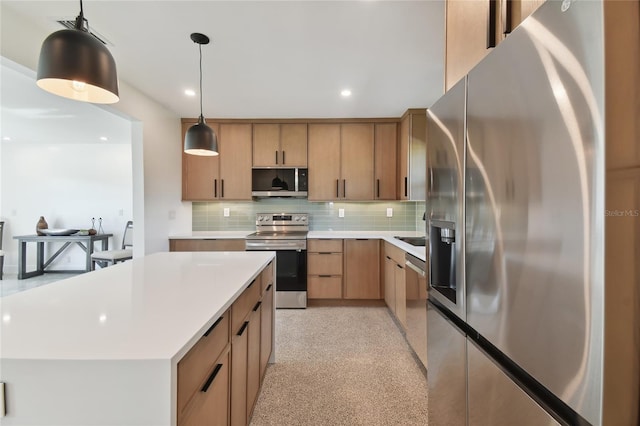 kitchen featuring backsplash, pendant lighting, a kitchen island, and stainless steel appliances