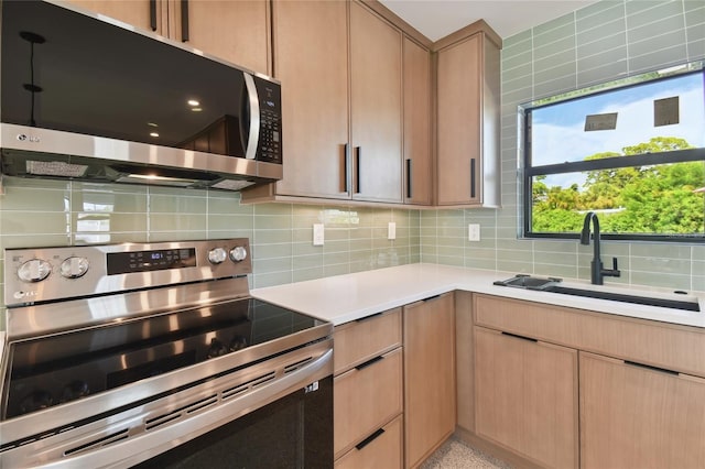 kitchen with stainless steel appliances, backsplash, and sink