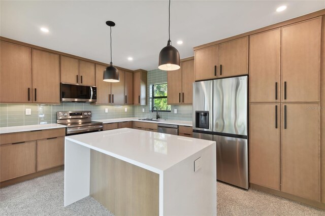 kitchen with decorative light fixtures, a kitchen island, stainless steel appliances, backsplash, and sink