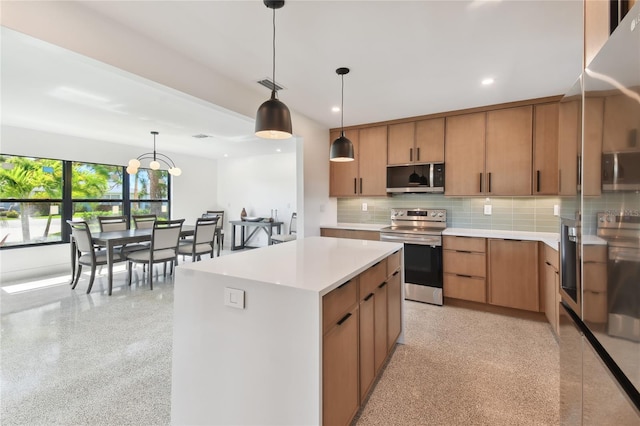 kitchen with a center island, an inviting chandelier, appliances with stainless steel finishes, backsplash, and pendant lighting