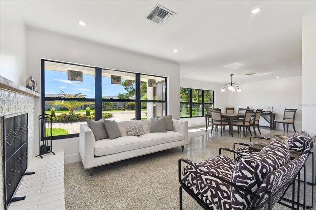 living room featuring a fireplace and a chandelier