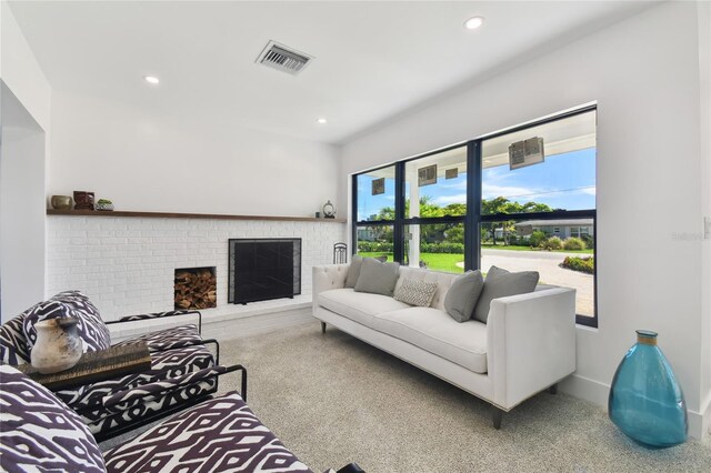 carpeted living room with a fireplace