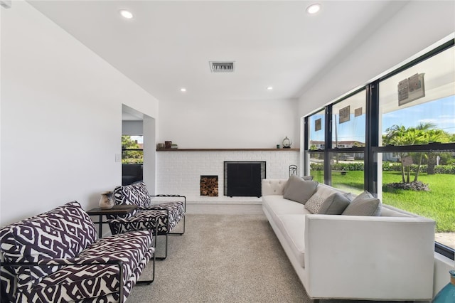 living room featuring plenty of natural light, a fireplace, and light carpet