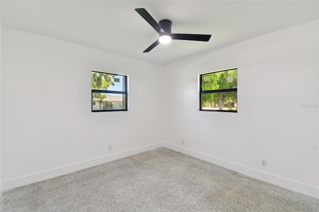 unfurnished room featuring ceiling fan and carpet