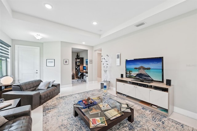 living room featuring a raised ceiling